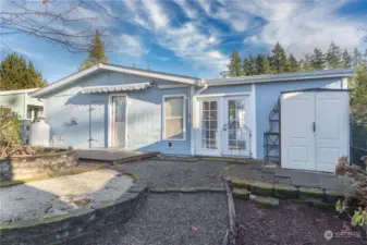 Back of the house with a storage shed for your garden tools.