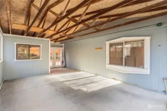 Carport with storage room through the left most window.