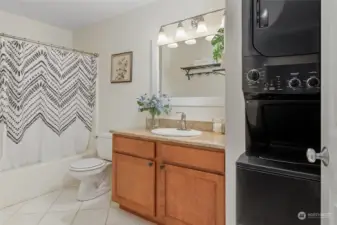 Another view of bathroom with laundry closet including washer & dryer (included).