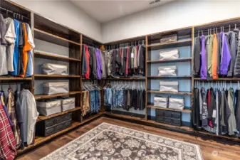 HUGE walk-in closet with custom built wood shelves and organizers