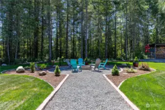 Gravel path leads to amazing entertaining space with firepit   Low maintenance private yard with custom curbing