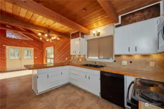 This kitchen is open to the living room, so you won't miss any of the action while preparing food for your guests. It has a breakfast bar, and plenty of cabinet and counter space.