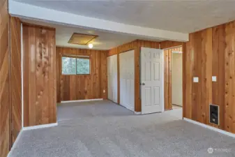 Sitting area or a dresser under the window give this primary bedroom a lot of space