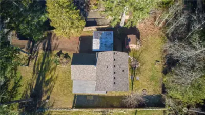 Aerial view of the property. Partial privacy fencing on both sides of the home