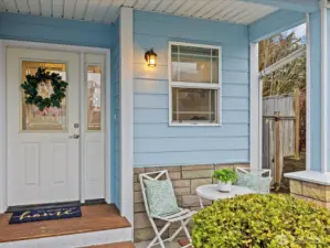 Covered front patio with leaded glass front door.