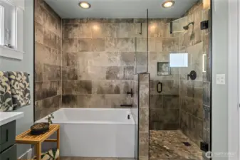 Soaking tub and custom tiled shower.