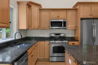 Stainless steel appliances, granite countertops, large kitchen island with cabinetry on both sides!