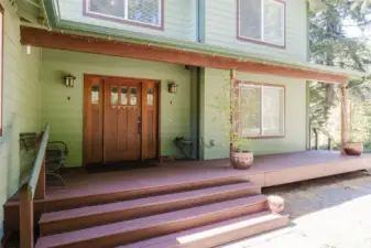 Trex style decking leads you up to the front door with nods to the Craftsman style architecture in the front door and lights.