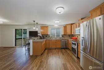 Generous kitchen with newer appliances and large eat-in space at the bar as well as a large space for a table.  Western facing window and door get flooded with light in the afternoon and evening.  Best view while doing the dishes is a good PNW sunset.