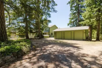 As you come in through the gate, the 3 car garage is the first thing you will see.  The house is to the left and the drive down to the shop is to the right.  Garage has 9ft doors so you can fit trucks easily!