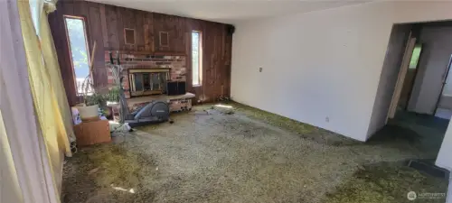 Living room with wood burning fireplace.