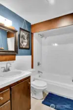 Subway tile surround and newer floors in the main bath.
