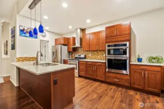 Custom kitchen with cherry cabinets and built in wall oven and microwave combo