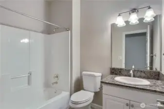 Full hall bath with granite counters.