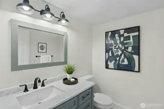 Convenient main-level powder room with modern updates in Everett townhome. virtually staged