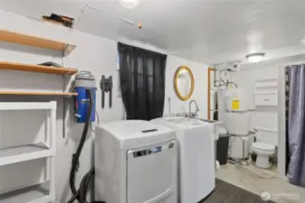 Large utility room with new washer and dryer units and 3/4 bath.