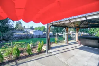 BACK PATIO OFF THE RECREATION ROOM WITH GAZEBO AND HOT TUB