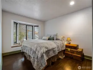The guest bedroom #1, has a window seat and a bay window that allows light.