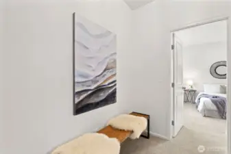 The hallway off the main floor bedroom is spacious enough for a wine display, a built in desk, mini library with seating area, or additional closet!