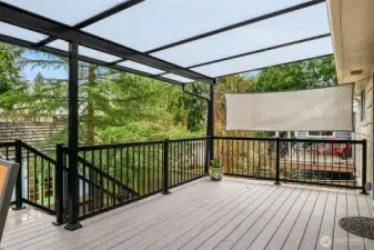 Main level covered deck with stairs to the back yard