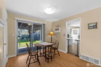 The dining room area overlooks the covered patio and backyard.