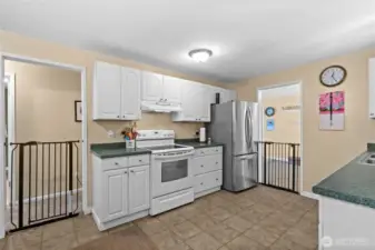 The kitchen has been updated with crisp white cabinetry and appliances.