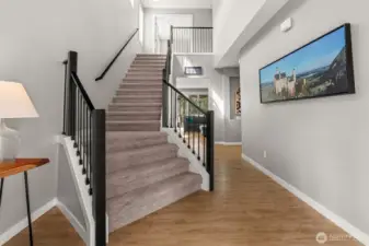 Vaulted ceilings and a grand staircase, this foyer has it all!