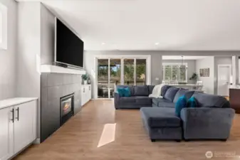 Bright and spacious, this open floor plan concept highlights this beautiful modern living room connecting to both the dining room and kitchen.