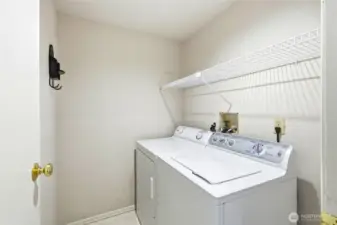 Convenient in-unit laundry area with storage space