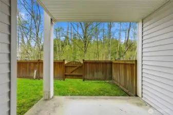 Covered patio overlooking fenced outdoor space