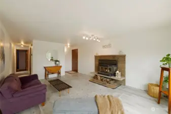 The living room has this magnificent wood burning fireplace (fireplace insert can be removed, should you wish). Newer laminate flooring, freshly painted