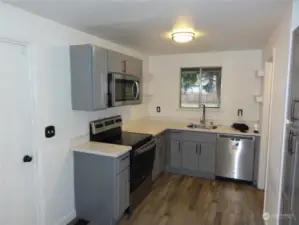 Beautifully updated kitchen with new cabinets, countertops, and appliances.