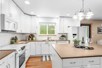 Kitchen window looks out to fully fenced private backyard