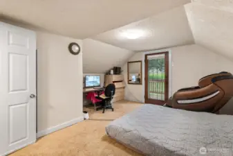 The other upstairs room with door to the upper deck looking out over the property.