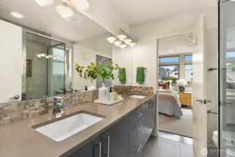 This bathroom has ample storage and the walk-in shower is to the right here.