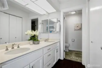 En-suite bathroom with double vanity and bathtub.