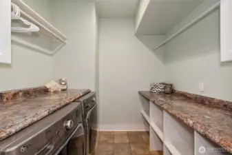 Main floor laundry offers abundant storage and counter space