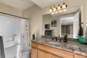 Fresh and functional guest bathroom with tub-shower combo