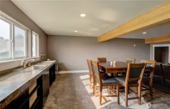 A stunning entertainment room featuring rich finishes, and a sleek wet bar for effortless hosting