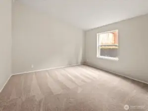 Vaulted ceilings continue in the 2nd bedroom