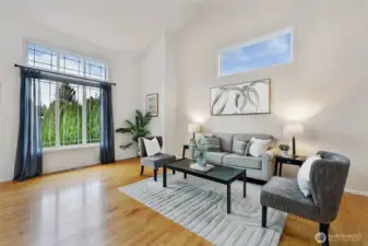 Dramatic windows flood the living area with natural light.