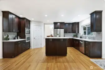 Built-in stainless steel appliances blend seamlessly into the rich espresso cabinetry.