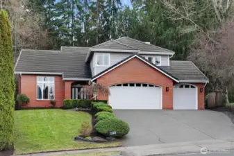 Three-car garage plus additional driveway parking.