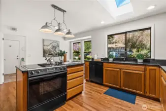 A downdraft stove is featured in the island.  The front yard view makes doing dishes not seem too bad, right?