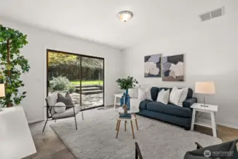 The family room is accommodating in size and offers access to the back yard and patio for summer enjoyment!