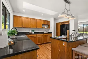The kitchen features beautiful oak cabinetry and granite countertops.  New recessed lights have also been installed.