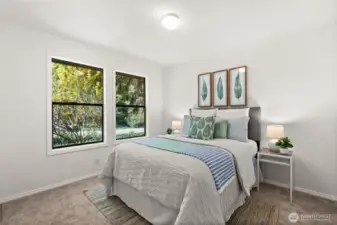 Bedroom #2. All three bedrooms are generously sized, each with windows that showcase the beautiful surrounding landscape.