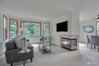 Spacious view living and dining rooms with fireplace.