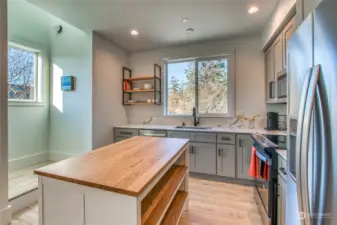 The hallway connects two upstairs ensuite bedrooms, with a laundry area conveniently located at the top of the stairwell. These windows face north and west.