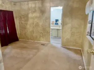 Primary bedroom looking into bathroom